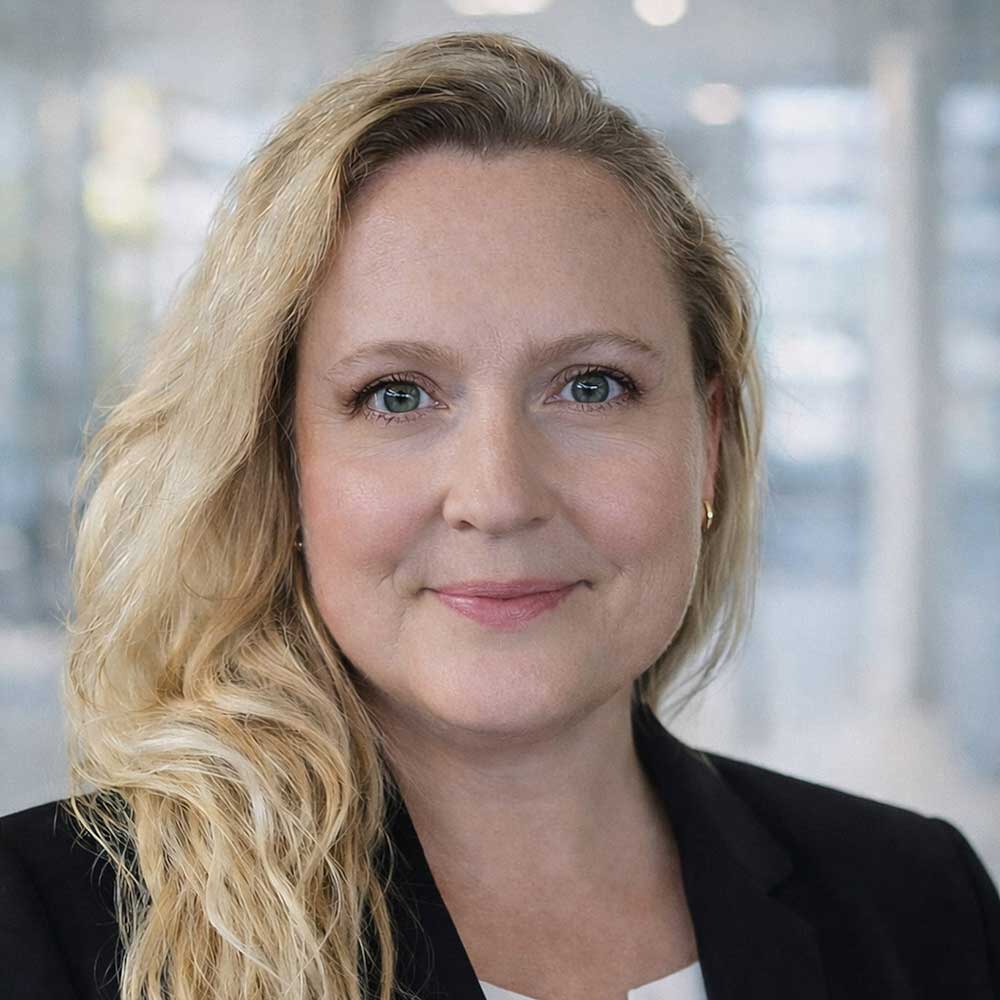 Professional headshot of blonde woman in office setting