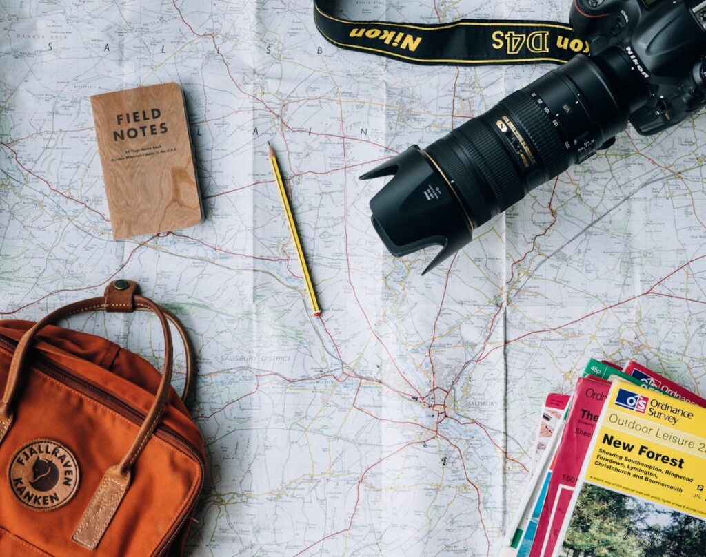 Traveler planning a journey over a map